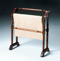 an old fashioned wooden chair with a white blanket on it's back and legs