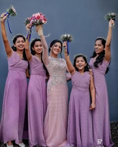 the bride and her bridesmaids are all wearing purple dresses with their bouquets