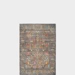 a rug with an intricate design on the front and back side, in grey tones