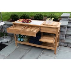 a wooden table with drawers and drinks on it