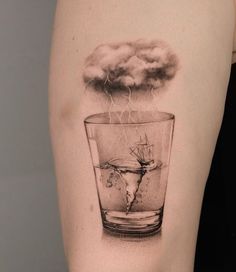 a black and white photo of a glass with steam coming out of it on the arm