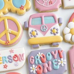 decorated cookies with peace signs, flowers, and hippies are displayed on a white surface