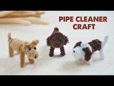 three small knitted dogs standing next to each other on a white surface with the words pipe cleaner craft written above them