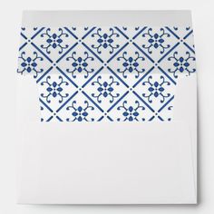 an envelope with blue and white designs on the front, inside and outside of it