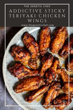 a white plate topped with chicken wings on top of a table