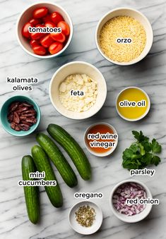 the ingredients for cucumber salad laid out on a marble counter top