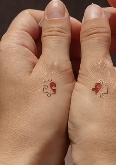 two hands with matching tattoos on them holding onto each other's thumbnails