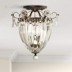 a chandelier hanging from the ceiling in a room with white walls and ceilings