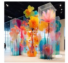 colorful glass vases with flowers in them on display