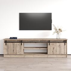 an entertainment center with a flat screen tv mounted on the wall