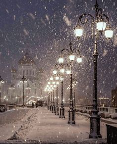 an instagram page with snow falling on the street lights