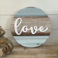 a wooden sign with the word love painted on it