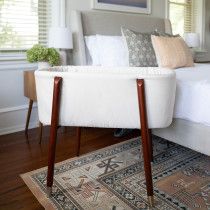 a white bed sitting on top of a wooden floor