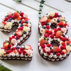 a cake shaped like the number twenty six with strawberries, roses and other fruits