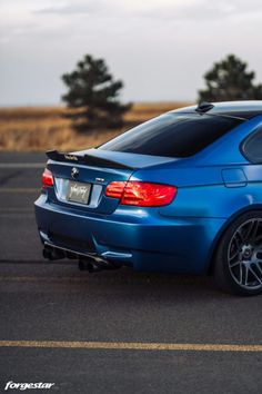 a blue bmw is parked in the parking lot