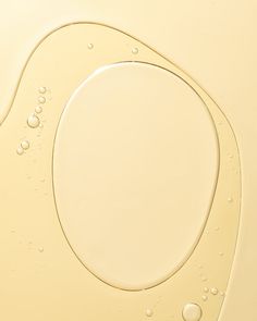 water bubbles in the shape of an oval on a yellow background with space for text