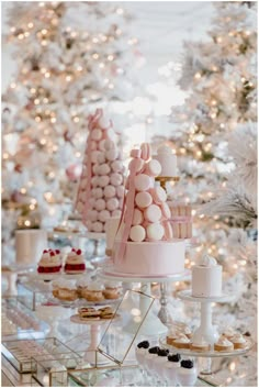 an assortment of desserts and pastries on display in front of a christmas tree