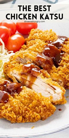 the best chicken katsu is served on a plate with tomatoes and lettuce