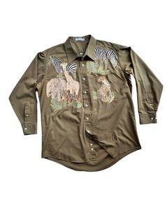 Explore the wild in style with these unique, one-of-a-kind olive green safari shirts, adorned with intricately embroidered patches inspired by zoo animals (Zebra Giraffe Tiger Elephant Dear Cheetah). This shirt tells a story of adventure and conservation, perfect for animal lovers and outdoor enthusiasts alike. Crafted with comfort in mind, these shirts are gently used and ready for their next journey. Add a touch of safari chic to your wardrobe and support wildlife conservation efforts with the Safari Shirts, Animals Safari, Safari Chic, Safari Shirt, Patchwork Shirt, Safari Theme, Animals Artwork, Wildlife Conservation, Green Button