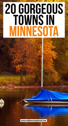 a boat with a blue tarp on it floating in the water next to trees