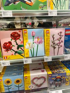 the shelves are filled with legos and flower cards for sale at toys r us