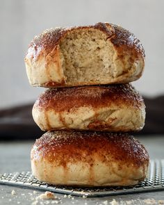 three doughnuts stacked on top of each other with powdered sugar sprinkled on them