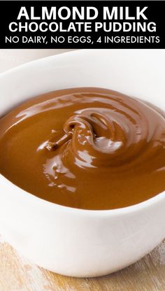 chocolate pudding in a white bowl with text overlay reading almond milk chocolate pudding no dairy, no eggs, 4 ingredients