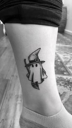 a small black and white tattoo on the ankle