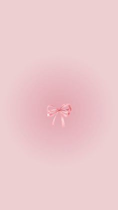 a pink wall with a bow on the top and one side that is slightly open