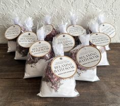 six bags of dried lavender sitting on top of a wooden table