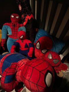 several stuffed animals are sitting on top of each other in the shape of spider - man