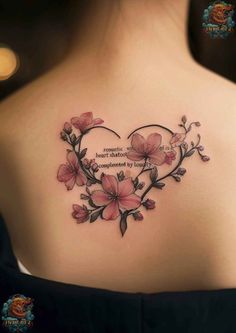 the back of a woman's shoulder with pink flowers and a quote on it