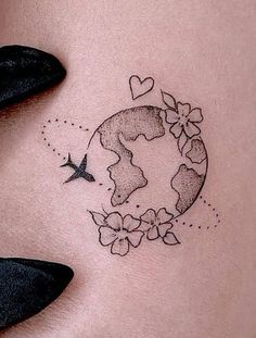 a woman's stomach with a small tattoo on the side of her belly and an airplane flying over it