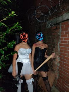 two women dressed up in costumes and masks