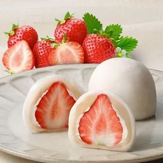 some strawberries are sitting on a plate next to an egg