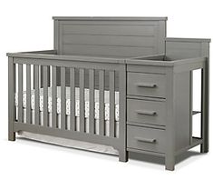 a baby crib with drawers and changing table