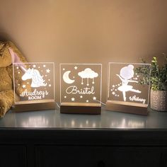 three clear acrylic blocks with the names of different children's rooms on them