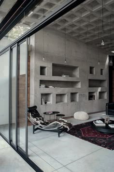 a living room filled with furniture and lots of windows