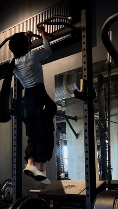 a person jumping in the air on a gym machine