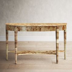 an old console table in the middle of a room with white walls and wood flooring