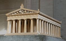 a wooden model of the parthenion with statues on it's pedestals