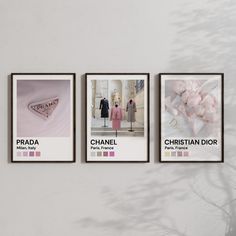 three framed photographs hang on the wall in front of a vase with pink flowers and two mannequins