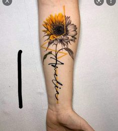 a sunflower with the word faith written in cursive writing on its arm