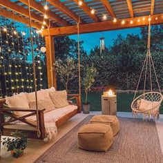 an outdoor living area with swings and lights