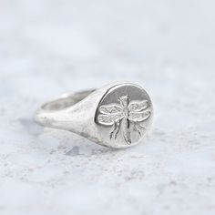 Our classic round signet has been hand engraved with a wax seal dragon fly. We are able to custom make any signet ring with your initials or family crest. Face measures 11mm round. Pictured with a high shine finish. For a matte finish, please leave a note at checkout. Silver And Gold Rings, Dragon Fly, Cozy Style, Wax Seal, Family Crest, Cozy Fashion, Wax Seals, Hand Engraving, Jewelry Inspo