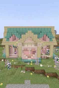 a small house in the middle of a field with flowers and grass on each side