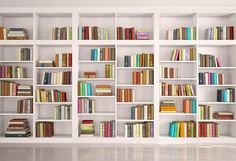 a white book shelf filled with lots of books