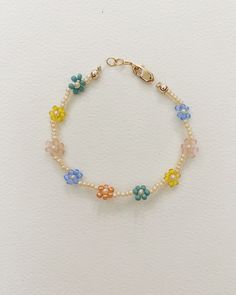 - colorful spring beads made into flowers - gold filled clasp and chain  - handmade with love  - quality material  This bracelet is a must have! It is a perfect addition to any stack of bracelets.  Each bracelet has an extender chain so it can be worn through out the years.  Don't only get it for your daughter-there are adult sizes! Get a Mommy & Me set so you can twin with your baby girl.   **Use these sizes as a guide, but to insure a good fit take a piece of yarn, wrap it around the wrist to take a measurement, then place it on a ruler. Flower Bead Bracelet, Girl Presents, Stack Of Bracelets, Toddler Bracelet, Toddler Girl Gifts, Beads Flower, Mesa Arizona, Presents For Girls, Baby Bracelet