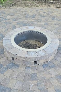 a fire pit sitting on top of a brick patio