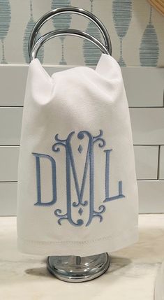 a monogrammed towel holder with the letter dml on it